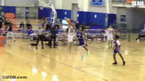 A Basketball Game Is Being Played In A Gym With The Word Slam On The Bottom Right GIF