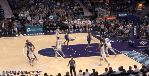 A Basketball Game Is Being Played In A Stadium With A Banner For Spectrum In The Background GIF