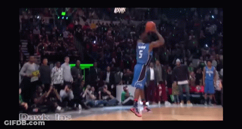 A Basketball Game Is Being Played In A Stadium With A Crowd Watching GIF