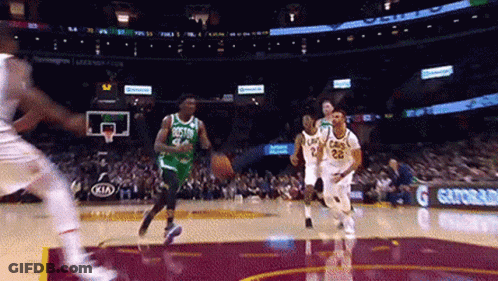 A Basketball Game Is Being Played In A Stadium With A Gatorade Ad In The Background . GIF