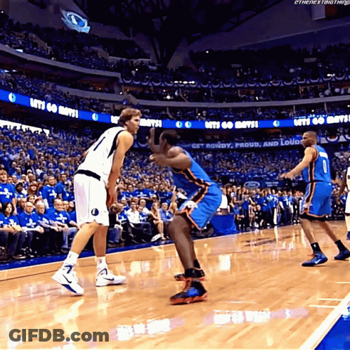 A Basketball Game Is Being Played In A Stadium With A Sign That Says Let 'S Go Mavs GIF