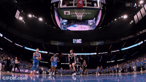 A Basketball Game Is Being Played In A Stadium With Ads For State Farm And Mdf Bank GIF