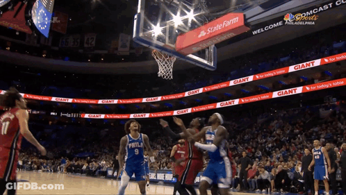 A Basketball Game Is Being Played In A Stadium With Giant Advertisements GIF