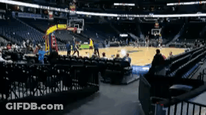 A Basketball Game Is Being Played In An Empty Stadium With People Sitting In The Stands . GIF