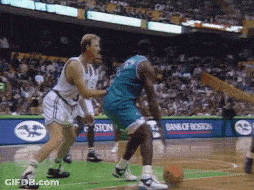 A Basketball Game Is Being Played In Front Of A Bank Of Boston Ad GIF