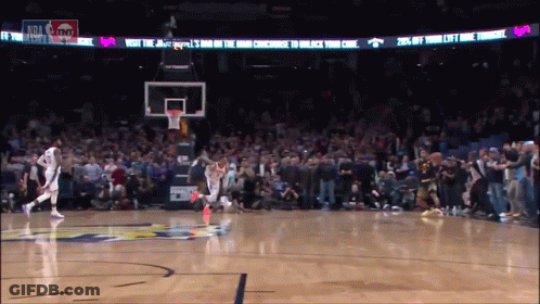 A Basketball Game Is Being Played In Front Of A Banner That Says Visit The Jazz Bar On The Way Concourse To Unlock Your GIF