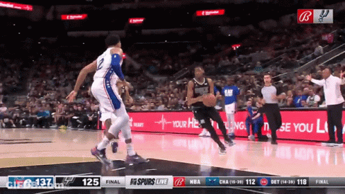 A Basketball Game Is Being Played In Front Of A Banner That Says " Your Heart " GIF
