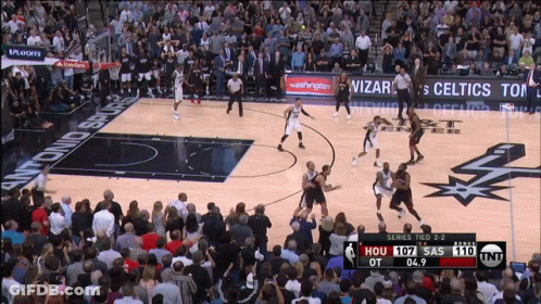 A Basketball Game Is Being Played In Front Of A Crowd GIF