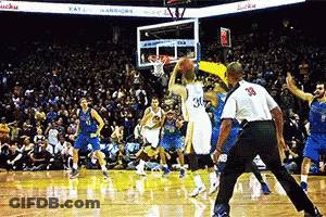 A Basketball Game Is Being Played In Front Of A Crowd And A Referee With The Number 39 On His Back GIF