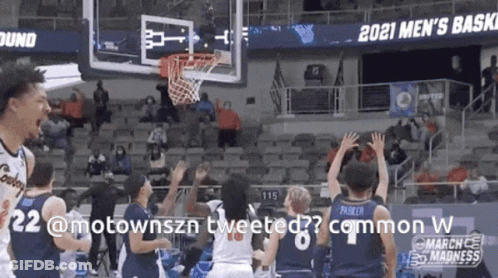 A Basketball Game Is Being Played In Front Of A Crowd And A Sign That Says 2021 Men 'S Basketball GIF