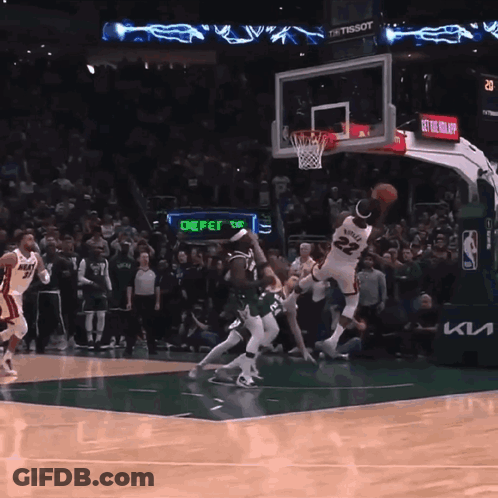 A Basketball Game Is Being Played In Front Of A Crowd And A Sign That Says Defer GIF