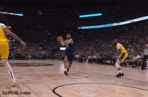 A Basketball Game Is Being Played In Front Of A Crowd And A Sign That Says ' Toyota ' On It GIF