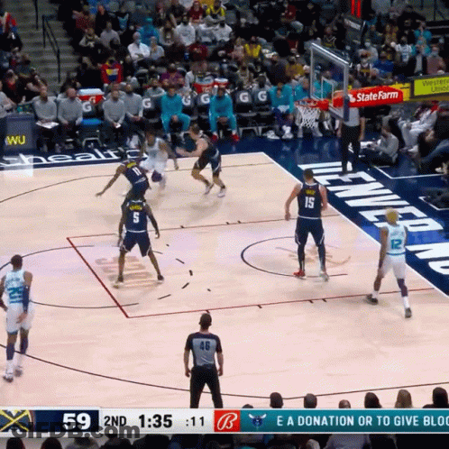 A Basketball Game Is Being Played In Front Of A Crowd And The Score Is 59 To 11 GIF