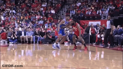 A Basketball Game Is Being Played In Front Of A Crowd Of People GIF