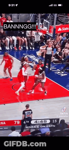 A Basketball Game Is Being Played In Front Of A Crowd Of People . GIF