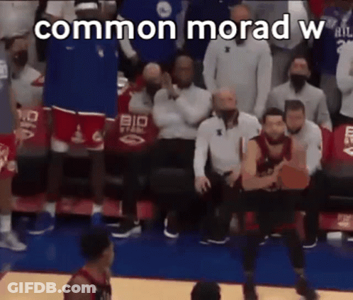 A Basketball Game Is Being Played In Front Of A Crowd Of People And A Basketball Player Is Jumping In The Air . GIF