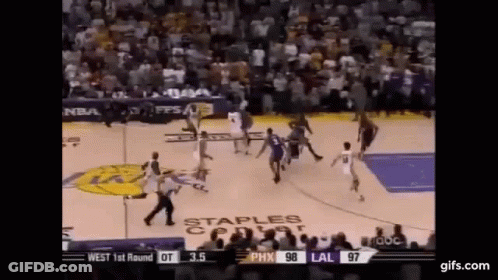 A Basketball Game Is Being Played In Front Of A Crowd . GIF
