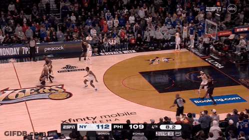 A Basketball Game Is Being Played In Front Of A Crowd Sponsored By Xfinity Mobile And Peacock GIF