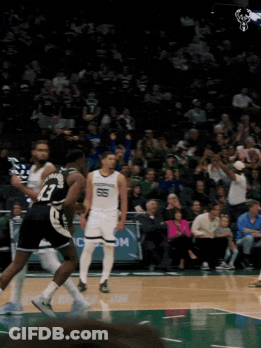 A Basketball Game Is Being Played In Front Of A Crowd That Is Watching GIF