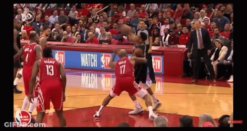 A Basketball Game Is Being Played In Front Of A Crowd With A Banner That Says Watch On It GIF