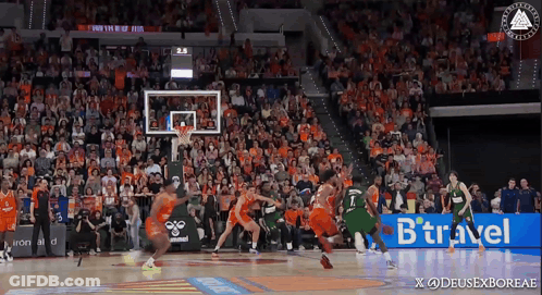 A Basketball Game Is Being Played In Front Of A Crowd With A Btraveler Ad In The Corner GIF