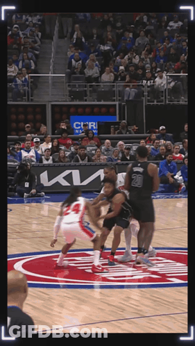 A Basketball Game Is Being Played In Front Of A Crowd With A Kia Ad GIF