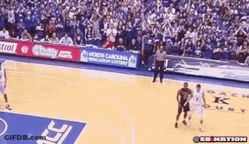 A Basketball Game Is Being Played In Front Of A Crowd With A North Carolina Education Lottery Banner GIF