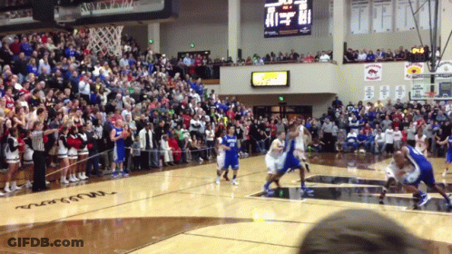 A Basketball Game Is Being Played In Front Of A Crowd With A Scoreboard That Shows The Score Of 41 To 17 GIF