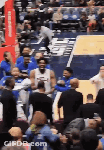 A Basketball Game Is Being Played In Front Of A Crowd With A Sign That Says Chase On It GIF
