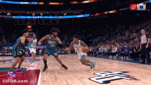 A Basketball Game Is Being Played In Front Of A Crowd With A Sign That Says Fire On It GIF