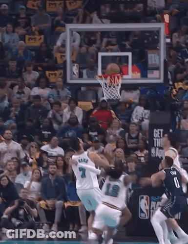 A Basketball Game Is Being Played In Front Of A Crowd With A Sign That Says " Play In Purnama " GIF