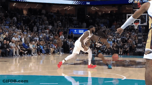 A Basketball Game Is Being Played In Front Of A Crowd With A Sonic Ad On The Wall GIF