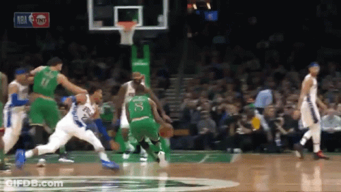 A Basketball Game Is Being Played In Front Of A Crowd With A Tnt Logo In The Background GIF