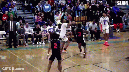 A Basketball Game Is Being Played In Front Of A Crowd With One Player Wearing The Number 2 GIF