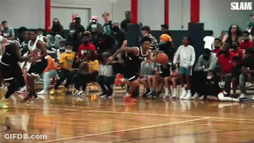 A Basketball Game Is Being Played In Front Of A Crowd With The Word Slam On The Bottom Right GIF