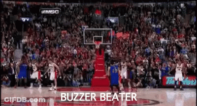 A Basketball Game Is Being Played In Front Of A Crowd With The Words Buzzer Beater Written On The Bottom . GIF