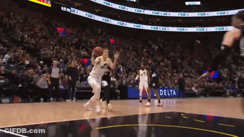 A Basketball Game Is Being Played In Front Of A Delta Advertisement GIF