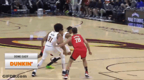 A Basketball Game Is Being Played In Front Of A Dunkin Advertisement GIF