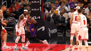 A Basketball Game Is Being Played In Front Of A Kia Ad GIF