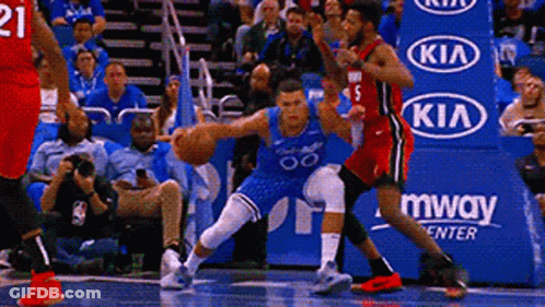 A Basketball Game Is Being Played In Front Of A Kia Advertisement . GIF