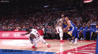 A Basketball Game Is Being Played In Front Of A Kia Sign GIF