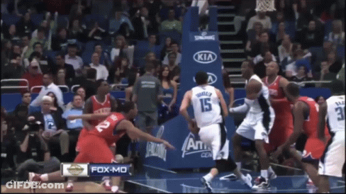 A Basketball Game Is Being Played In Front Of A Kia Sign GIF