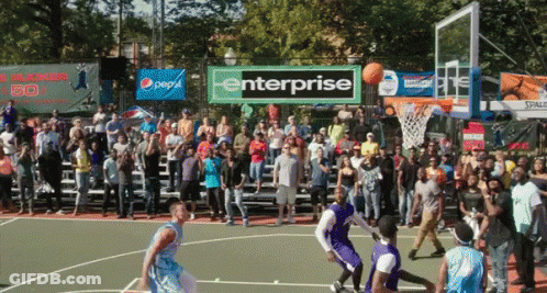 A Basketball Game Is Being Played In Front Of A Large Crowd And A Banner That Says Enterprise GIF
