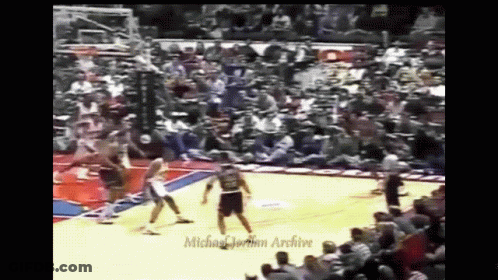 A Basketball Game Is Being Played In Front Of A Michael Jordan Archive Audience GIF