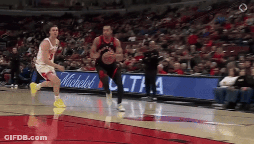 A Basketball Game Is Being Played In Front Of A Michelle 'S Sign GIF