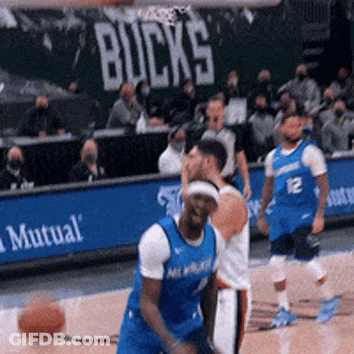 A Basketball Game Is Being Played In Front Of A Mutual Banner GIF