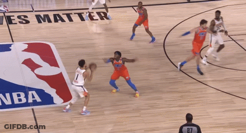A Basketball Game Is Being Played In Front Of A Nba Logo GIF
