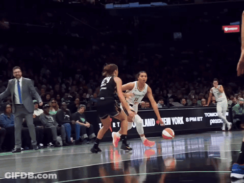 A Basketball Game Is Being Played In Front Of A New York Advertisement GIF