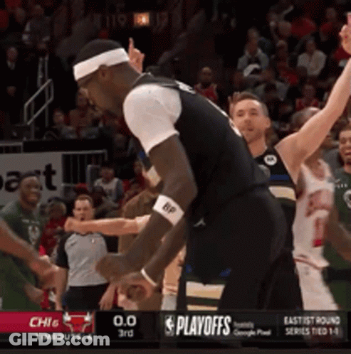 A Basketball Game Is Being Played In Front Of A Playoffs Banner GIF