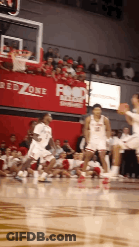 A Basketball Game Is Being Played In Front Of A Red Zone Advertisement GIF